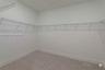 Walk-in closet featuring wall-to-wall carpeting and perimeter white wire shelving