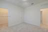 Neutral-toned carpeting, high ceilings, solid-core interior doors, and walk-in closet with built-in wire shelving