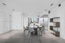 Open-concept space featuring large-format ceramic tile flooring, floor-to-ceiling windows, integrated stainless steel kitchen cabinetry, and recessed 
