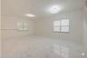Large room featuring polished stone-finish tile flooring, dual modern floral-style flush-mount lighting fixtures, and dual-layered horizontal window s