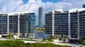 Modern high-rise architecture featuring expansive glass curtain walls, wrap-around balconies, deep-water access, and integrated ground-level swimming 