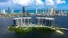 Waterfront high-rise complex situated on a private island, featuring tiered architectural profiles, expansive glass balcony systems, a central outdoor