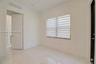 Interior space featuring light-toned stone-finish flooring, dual-panel interior door, banded window shades, and minimalist trim