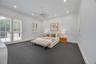 Spacious room featuring high ceilings with recessed lighting, integrated ceiling fan, plantation shutters, and double glass-paned doors