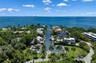 Waterfront residential property featuring direct canal access, deep-water dockage, palm-lined landscaping, and an expansive horizon over the bay