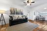 Terracotta tile flooring, crown molding, and a multi-light ceiling fan