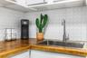 Butcher block countertops, white hexagonal tile backsplash, stainless steel undermount sink, and a gooseneck faucet