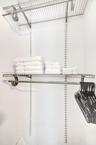 Adjustable storage system featuring white wire shelving, wall-mounted tracks, and an integrated hanging rod