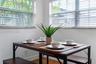 Dual windows featuring horizontal blinds and wood-finish flooring