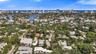 Aerial perspective featuring a residential lot with mature landscaping and proximity to regional waterways and urban coastal infrastructure