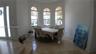 Arched windows, bay window configuration, and polished stone tile flooring