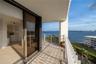 Covered balcony featuring tile flooring and a metal railing with water frontage