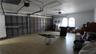 Multi-car garage featuring segmented metal overhead doors, overhead lighting fixtures, and arched windows