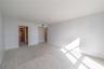 Neutral-toned wall paint, neutral carpeting, and recessed ceiling lighting