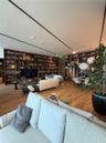 Extensive floor-to-ceiling custom built-in shelving, wood-finish flooring, and recessed linear track lighting