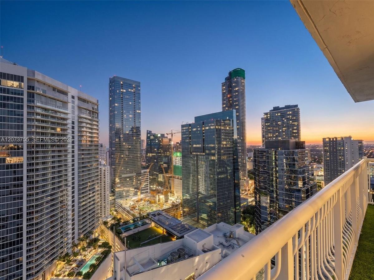 Private balcony with a metal railing and high-rise cityscape perspective