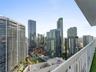 Private balcony featuring a metal railing and urban skyline exposure