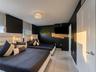 Ceramic tile flooring, crown molding-accented ceiling, crystal-style flush mount lighting, and custom roller shades