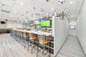 Built-in bar featuring wood-finish tile flooring, recessed ceiling lighting, a partial partition wall, and a horizontal wood-slat backsplash