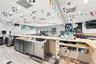 Service bar featuring a stone-look countertop, stainless steel under-counter cabinetry, integrated recessed lighting, and wood-finish flooring