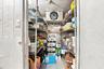 Commercial walk-in cooler featuring diamond plate metal paneling, industrial-grade cooling unit, and multi-tier wire shelving