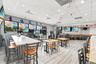 Spacious interior featuring wood-finish flooring, recessed lighting, and multiple large windows