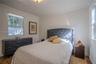 Interior space featuring crown molding, neutral wall color, dual-pane windows, and light-toned tile flooring