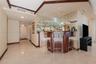 Dining area featuring recessed ceiling detail, crown molding, stone-finish flooring, and a multi-arm chandelier