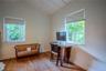 Vaulted ceilings, wood-finish flooring, and dual windows with stone sills