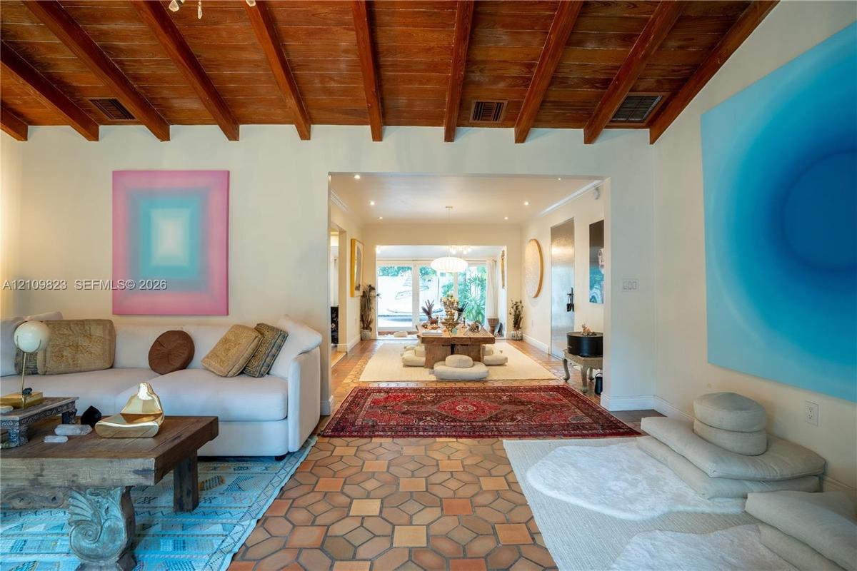 Exposed wood beam ceiling, geometric ceramic tile flooring, and recessed lighting