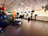 Open-concept room featuring high ceilings with recessed lighting, large windows, and durable flooring