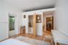 Wood-finish flooring, glass-paneled exterior door, and solid core interior door
