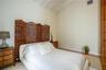 Vaulted ceiling, wood-finish flooring, and natural wood-toned vertical structural pillar