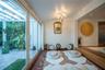 Multi-panel sliding glass doors, overhead pergola structure, terracotta tile flooring, recessed lighting, and raised wood-finish platform