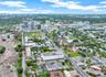 Aerial view of urban land parcel with mature trees and proximity to metropolitan infrastructure