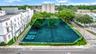 Corner lot featuring paved surface parking, established trees, and perimeter landscaping
