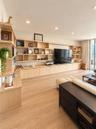 Custom floor-to-ceiling wood-finish cabinetry, extensive open shelving, recessed lighting, and wood-finish flooring