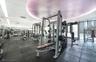 Fitness area featuring rubberized flooring, recessed architectural ceiling lighting, floor-to-ceiling windows, and multiple built-in strength training