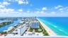 High-rise aerial perspective capturing coastal shoreline, expansive ocean horizon, and inland waterway