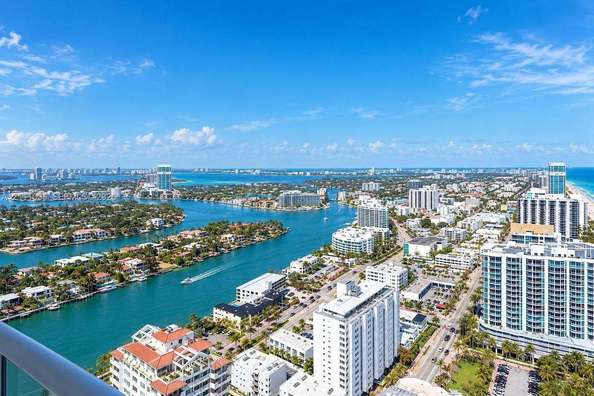 Aerial perspective featuring expansive coastal waterways, high-rise architecture, marina access, and proximity to the Atlantic shoreline