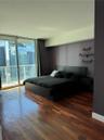 Floor-to-ceiling glass sliding doors, wood-finish flooring, and built-in wall shelving