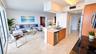 Kitchen featuring light-finish cabinetry, stone-surface countertops, dual-basin stainless steel sink with pull-down faucet, stainless steel dishwasher