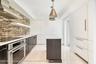 Sleek custom Kitchen with a service entrance door