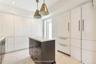 Sleek custom Kitchen with concealed Washer & Dryer
