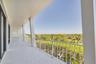 Expansive covered balcony spans the width of the living area and bedrooms