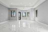 Living space featuring large-format tile flooring with a veined pattern, tray ceiling with recessed lighting, and multiple windows