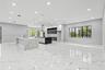 Open-concept kitchen featuring dual islands with veined stone-finish countertops, matte black plumbing fixtures, two-tone flat-panel cabinetry, and po