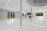 Open-concept interior featuring large-format stone-finish flooring, recessed lighting, a kitchen island with stone-finish countertop, structural suppo