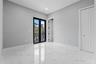 Large-format tile flooring with a veined pattern, recessed ceiling lighting, black-framed French doors, and a double-door closet with paneled detailin