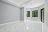 Polished tile flooring with marble-pattern veining, tray ceiling, recessed lighting, and large-paned windows